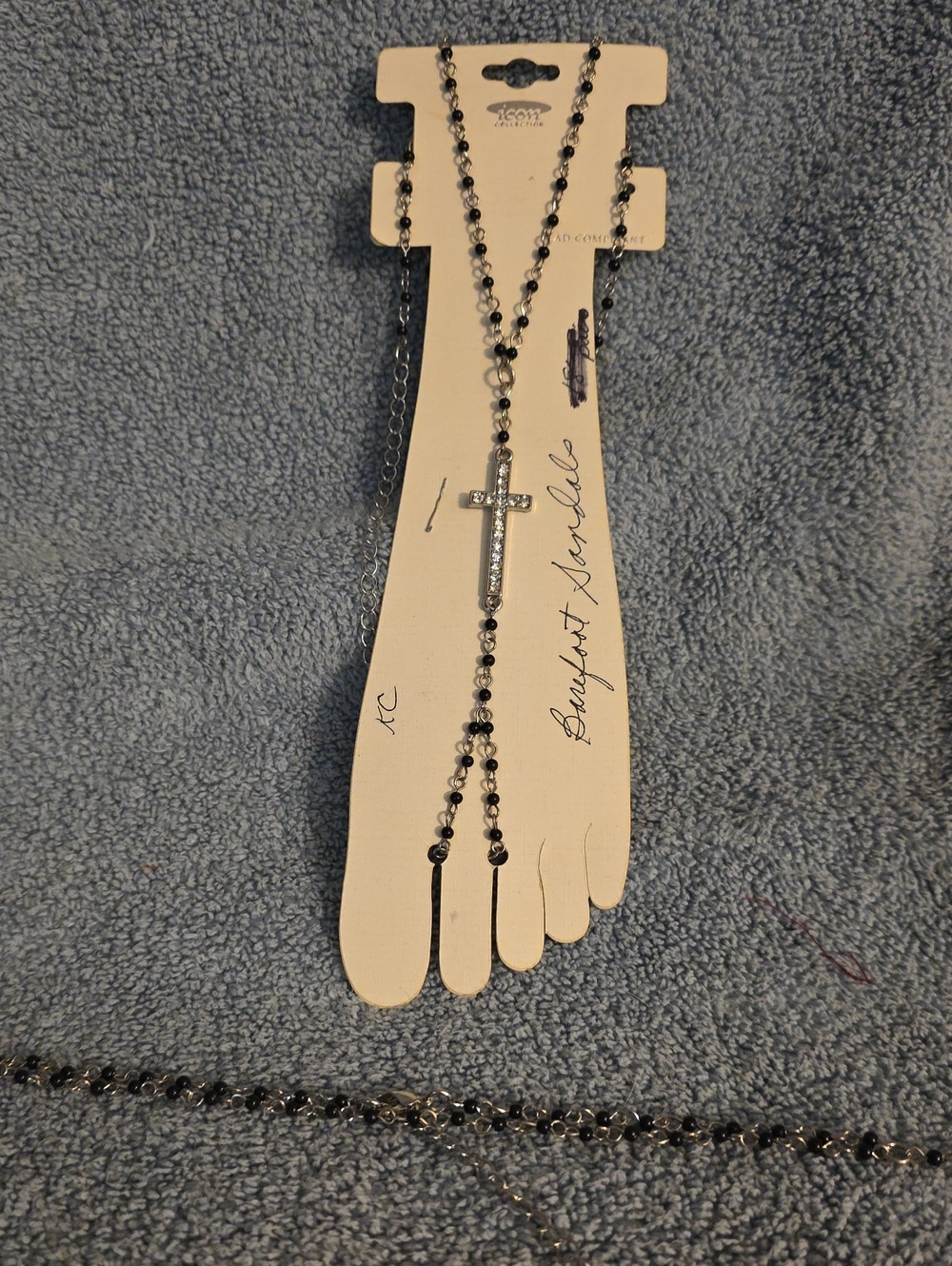 silver-tone and black bead body or foot chain styled like a barefoot sandal,